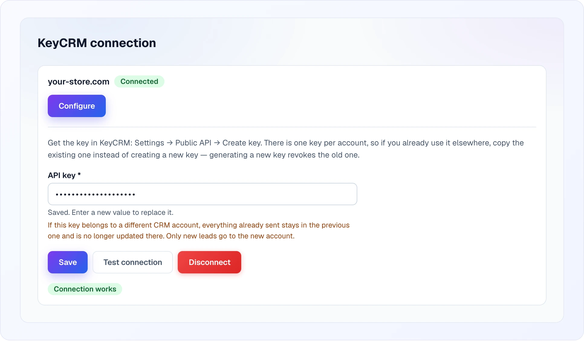 The open connection form of a connected site: the instruction on where to get the key in KeyCRM, the API key field with the hints "Saved. Enter a new value to replace it." and a warning about switching to another CRM account, the Save, Test connection and Disconnect buttons, and the green Connection works label